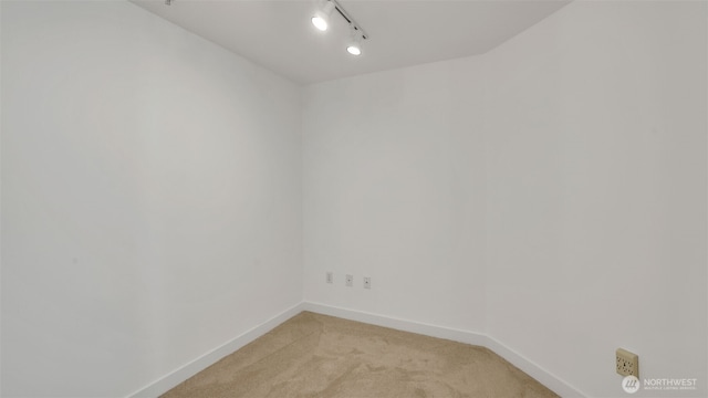 300 110th Ave NE Unit 605, Bellevue, WA 98004 - empty room featuring light colored carpet, baseboards, and track lighting