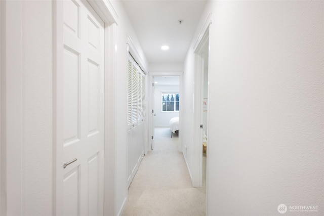 hall with light carpet, baseboards, and recessed lighting