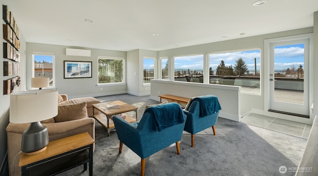 sitting room with recessed lighting, an AC wall unit, light tile patterned flooring, and baseboards