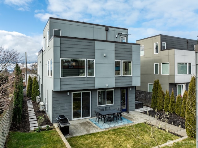 back of house with a yard, fence, and a patio