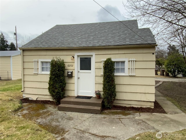 view of front of house with a shingled roof