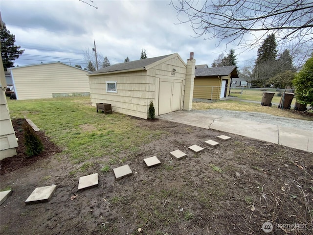 garage with driveway and fence