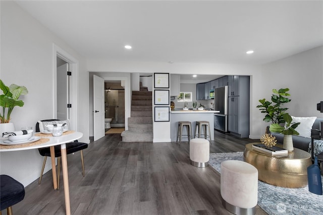 interior space featuring stairs, dark wood finished floors, and recessed lighting