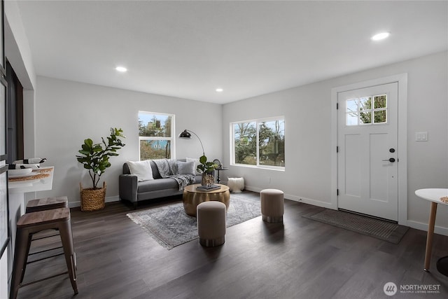 living area with recessed lighting, dark wood finished floors, and baseboards