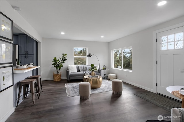 living area with dark wood-style floors, baseboards, and recessed lighting