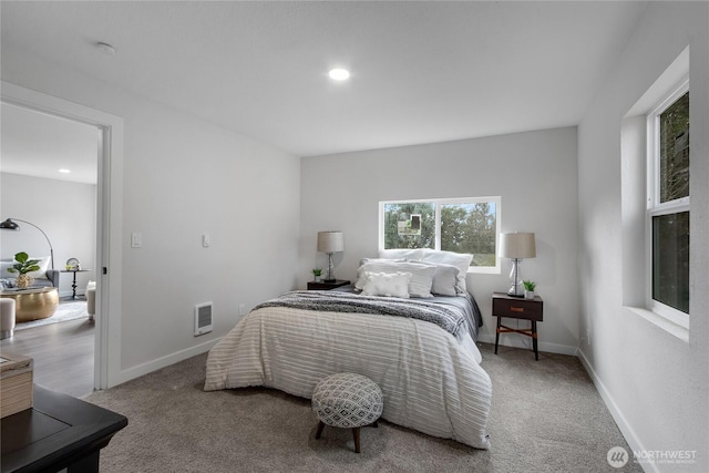 carpeted bedroom with recessed lighting, visible vents, and baseboards