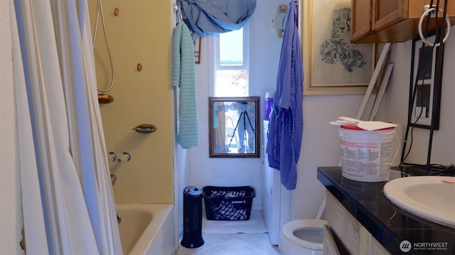 bathroom with toilet, tile patterned floors, a sink, and shower / bathing tub combination