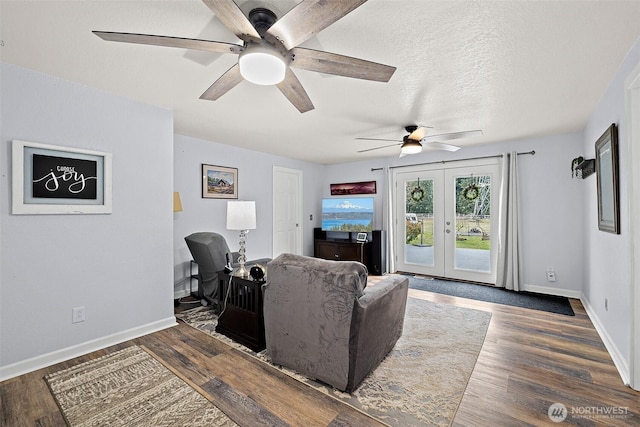 living area featuring dark wood-style floors, french doors, ceiling fan, a textured ceiling, and baseboards