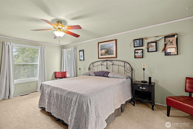 bedroom with baseboards, a ceiling fan, light colored carpet, and crown molding