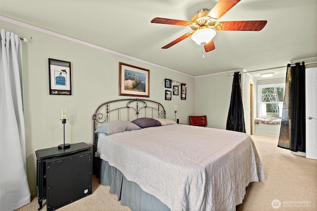 bedroom with light carpet, ornamental molding, and a ceiling fan