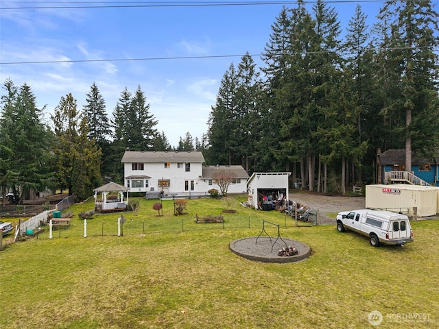 view of yard featuring fence and a gazebo