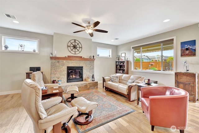 living area with recessed lighting, visible vents, light wood-style flooring, and baseboards