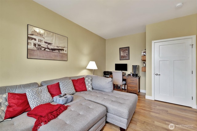 living room with light wood-style flooring and baseboards