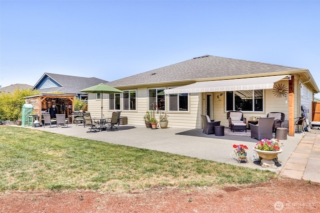 back of house featuring roof with shingles, a patio, an outdoor hangout area, and a lawn