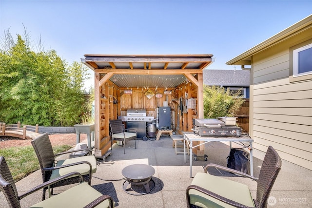 view of patio featuring grilling area and fence