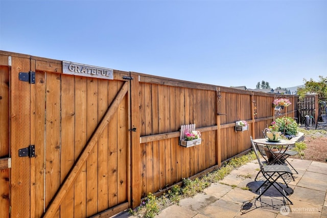 view of patio / terrace with fence and a gate