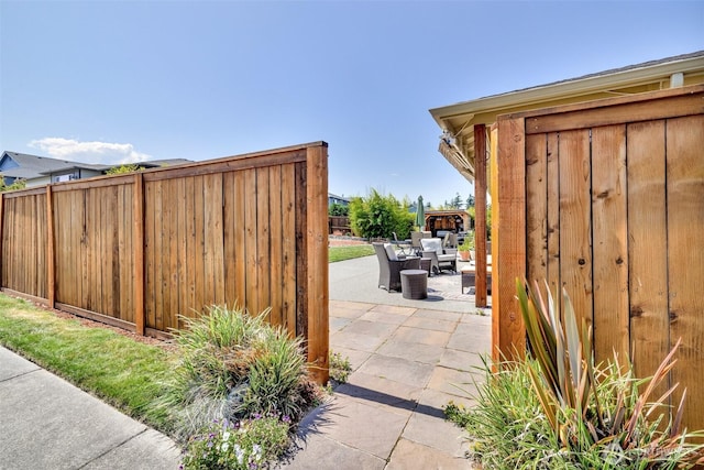 view of patio featuring outdoor lounge area and fence