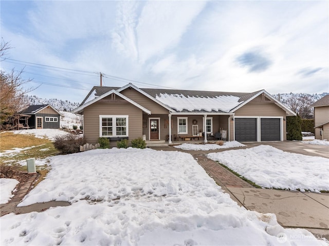 view of front of home featuring a garage, driveway, and covered porch