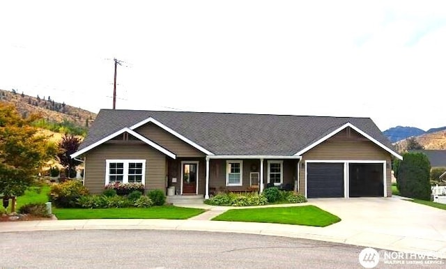 single story home with a garage, driveway, and a mountain view