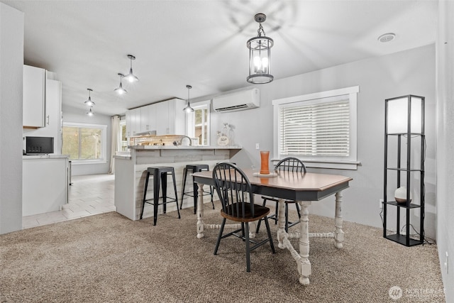 dining room featuring light tile patterned floors, an AC wall unit, and light colored carpet