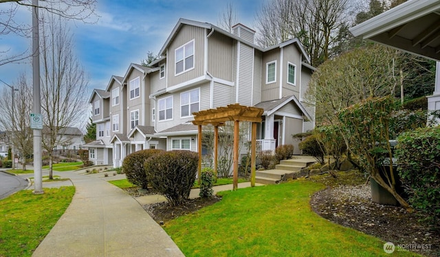 view of front of property with a residential view, a front lawn, and a pergola