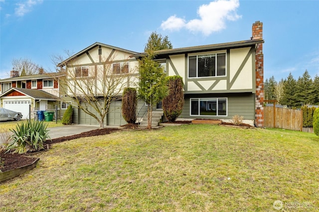 tudor house featuring a chimney, stucco siding, concrete driveway, a front yard, and fence