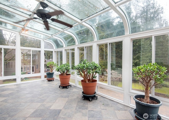 sunroom featuring a ceiling fan