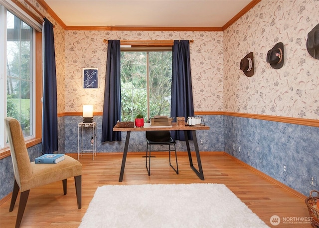 home office with ornamental molding, wainscoting, wood finished floors, and wallpapered walls