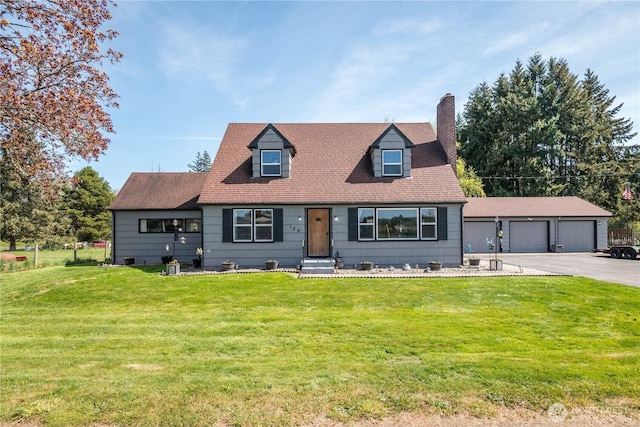 cape cod-style house with a detached garage, a chimney, and a front lawn