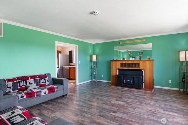 living room with ornamental molding, dark wood-style flooring, and baseboards