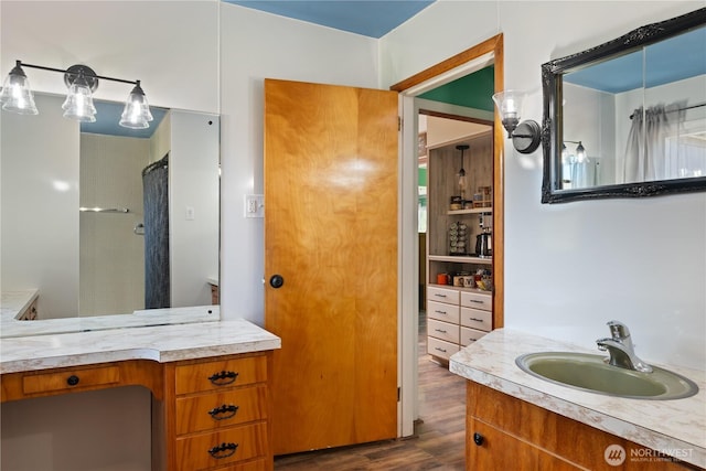 bathroom with wood finished floors and vanity