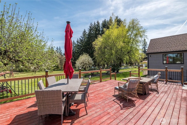 deck featuring a yard and outdoor dining space