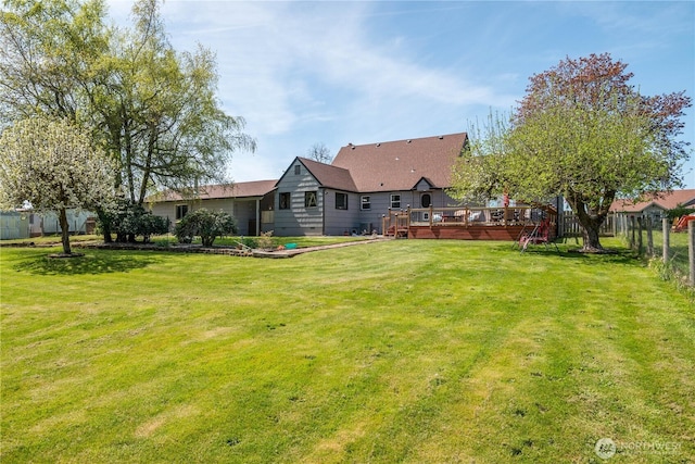 view of yard featuring fence and a deck