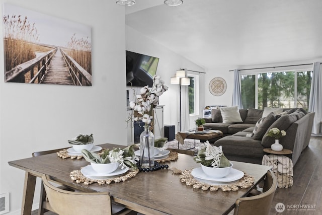 dining room with lofted ceiling, dark wood-style flooring, and visible vents