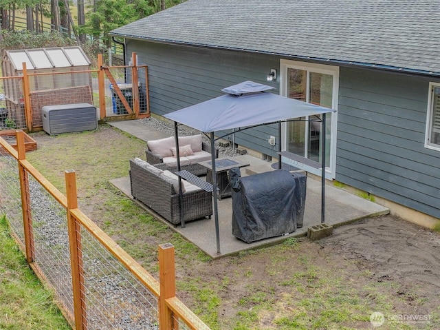 view of yard featuring an exterior structure, a patio area, fence, an outdoor structure, and an outdoor living space