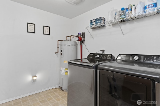 laundry room with laundry area, washing machine and dryer, water heater, and baseboards