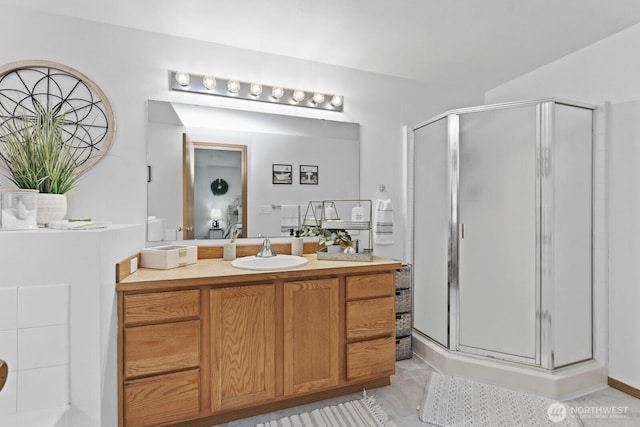 bathroom featuring a stall shower and vanity