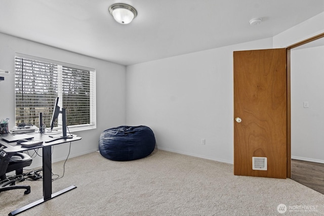 home office featuring baseboards, visible vents, and light colored carpet