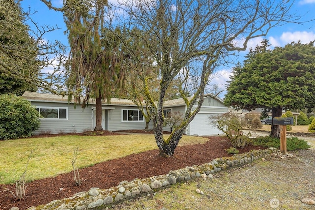 ranch-style house featuring an attached garage and a front yard