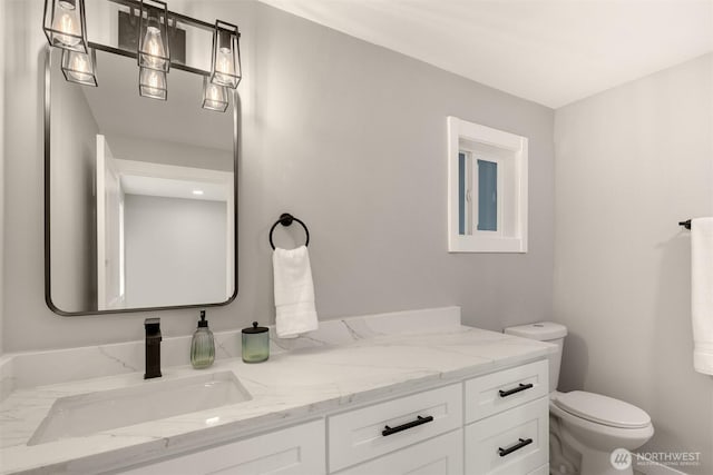 bathroom featuring toilet and vanity