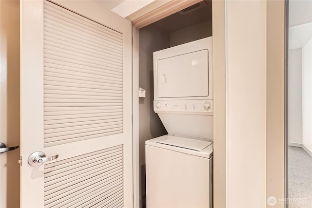 laundry room with stacked washer and dryer, visible vents, and laundry area