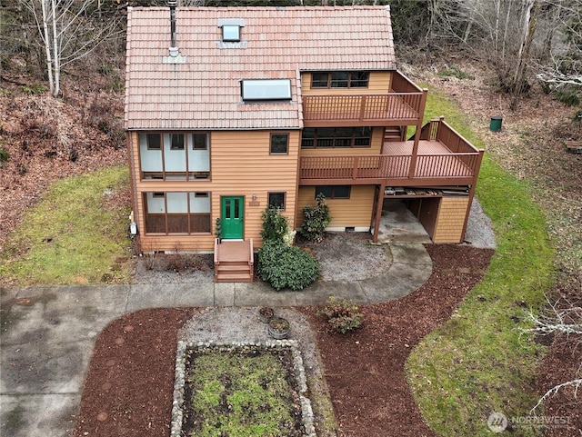 view of front facade with a tiled roof and crawl space