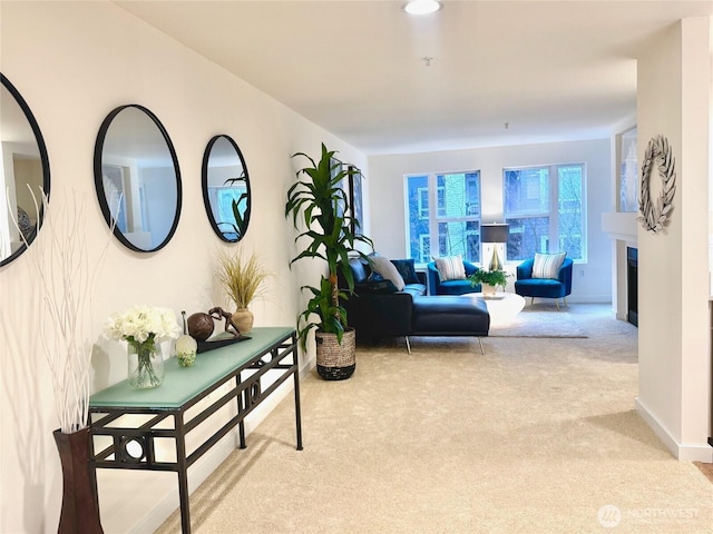 living area with light colored carpet and a fireplace