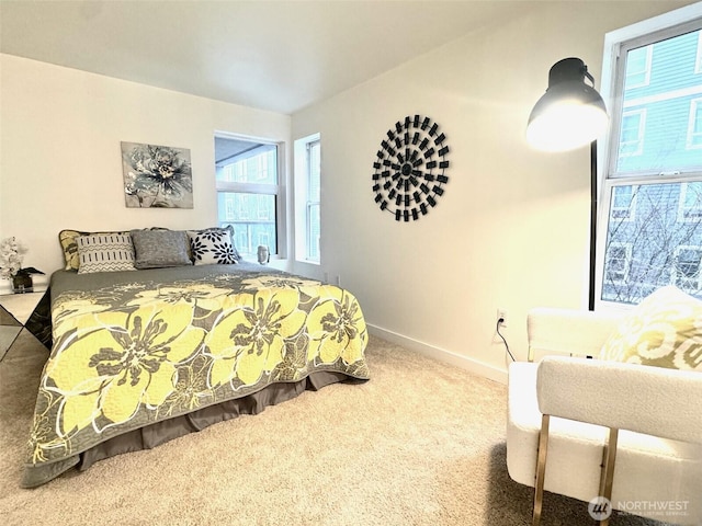 bedroom with carpet, multiple windows, and baseboards