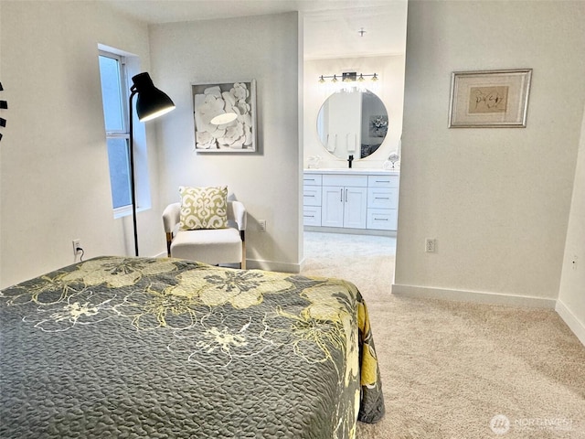 carpeted bedroom with baseboards and ensuite bathroom