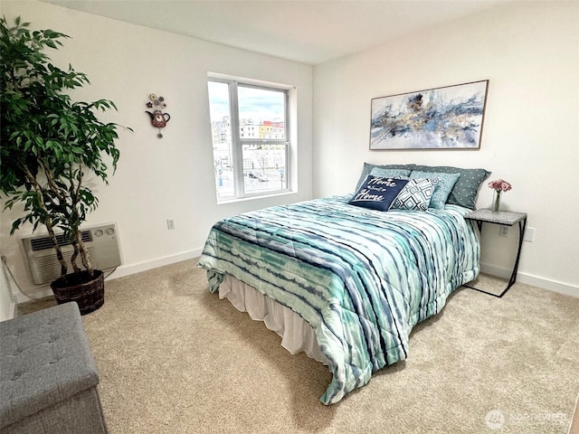 carpeted bedroom with a wall unit AC and baseboards