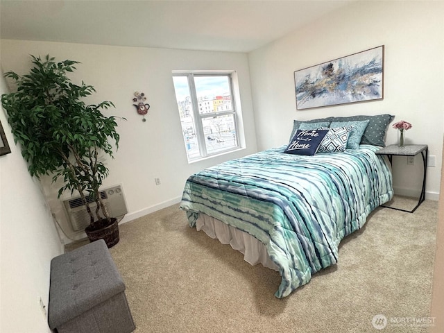 bedroom with an AC wall unit, carpet, and baseboards