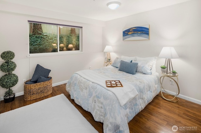 bedroom featuring wood finished floors and baseboards