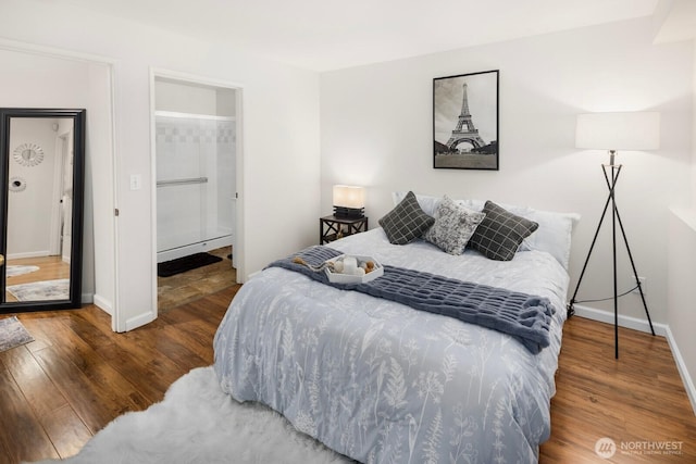 bedroom with baseboards and wood finished floors