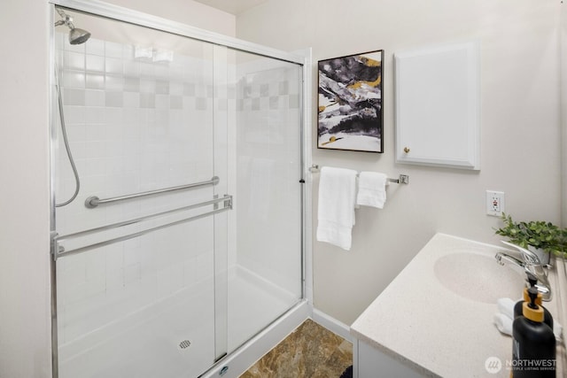 full bath with a shower stall, baseboards, and vanity